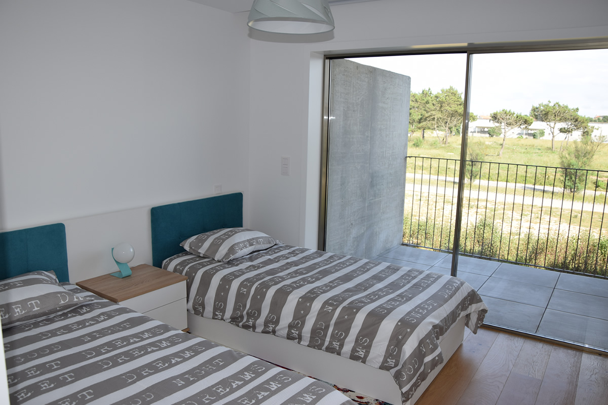 Third bedroom with 2 large single beds (1m wide), ensuite bathroom and private terrace.